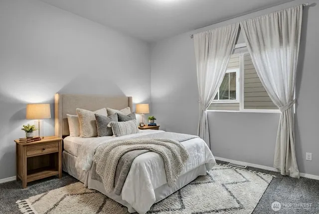 a bedroom with a bed and a window