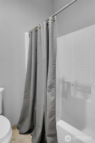 a bathroom with a shower and a toilet