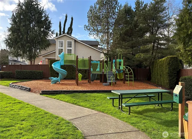 a front view of a house with porch and a garden