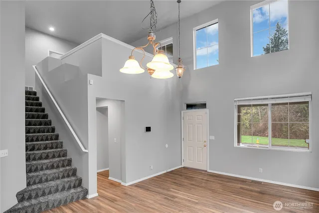 a view of entryway and hall with wooden floor