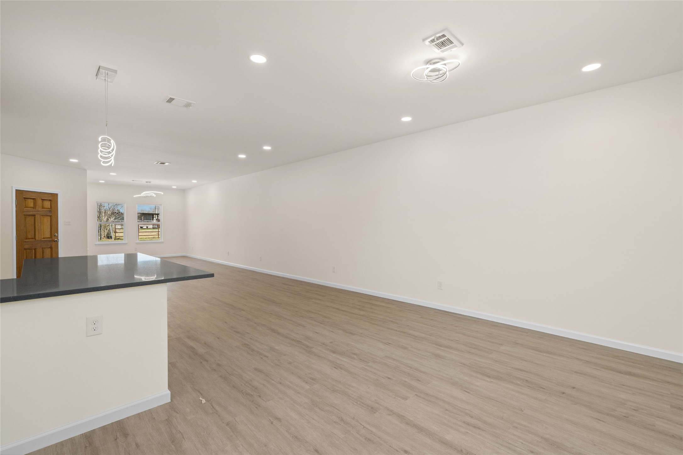 4656 North Teague Street Rosharon, TX 77583 - Photo 9 of 41 Bright, open living area with wide-plank flooring and recessed lighting throughout.