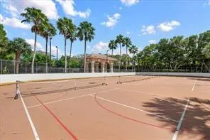 a view of swimming pool with palm trees