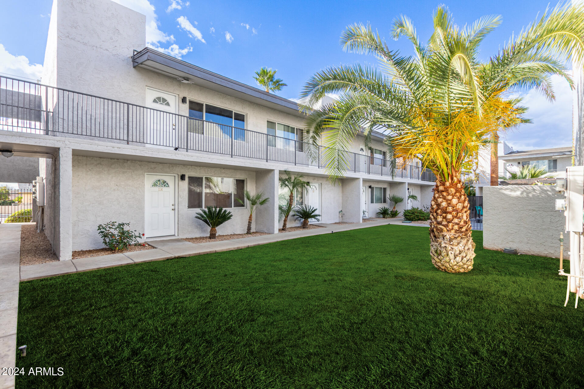 1602 East Ocotillo Road, Unit 121 Phoenix, AZ 85016 - Photo 1 of 31 a front view of a house with a garden and plants