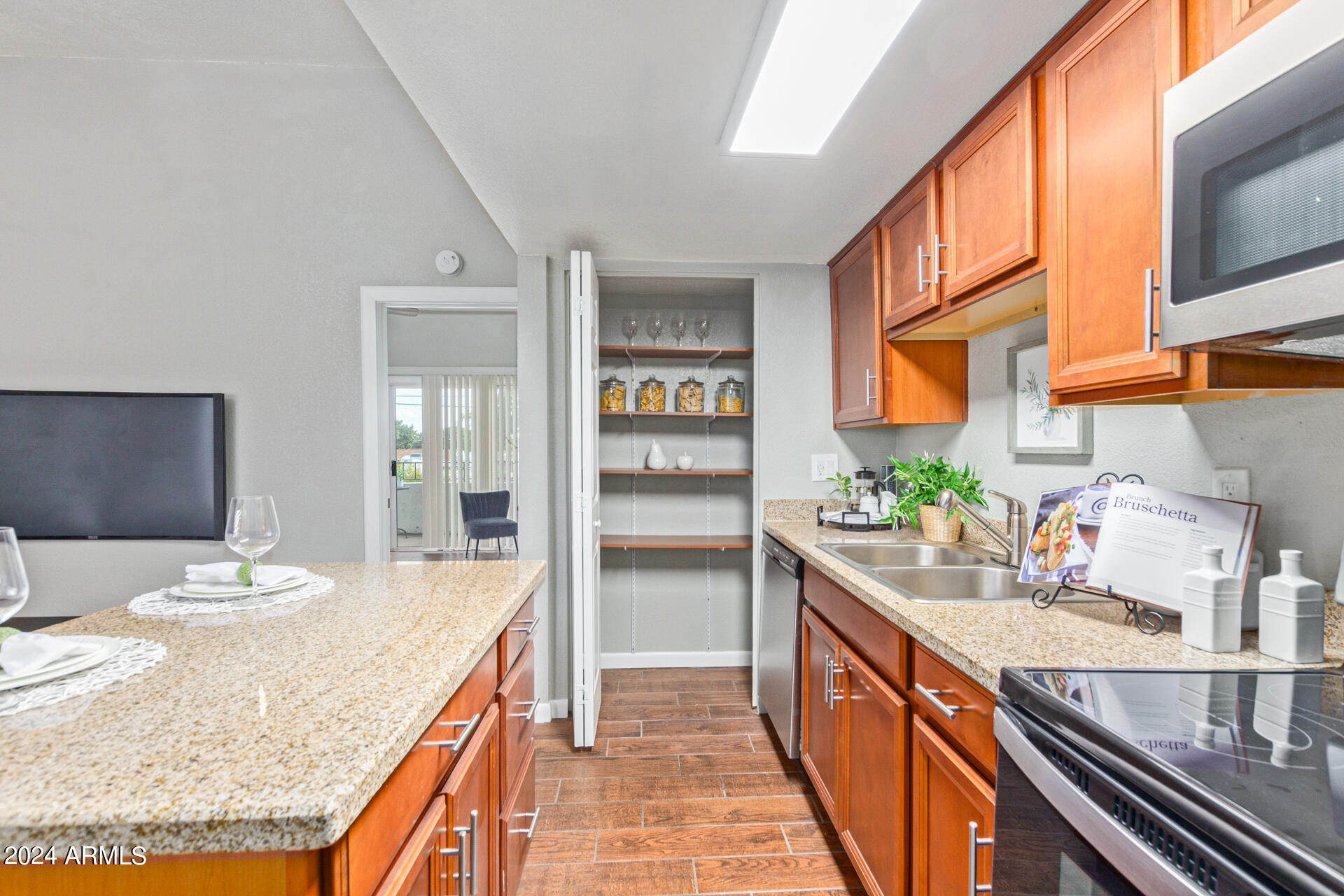 1602 East Ocotillo Road, Unit 121 Phoenix, AZ 85016 - Photo 11 of 31 a kitchen with stainless steel appliances granite countertop a sink and cabinets