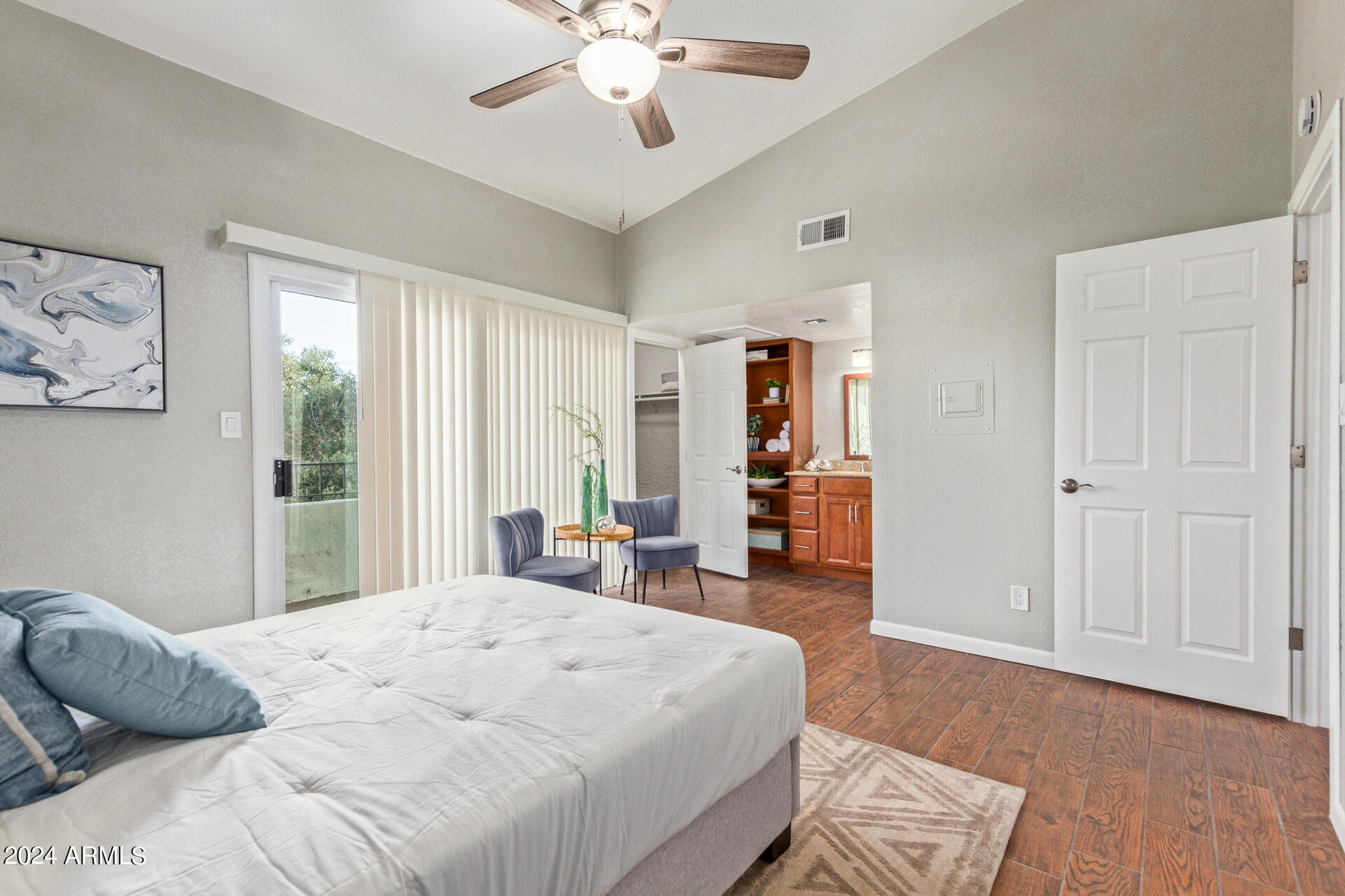 1602 East Ocotillo Road, Unit 121 Phoenix, AZ 85016 - Photo 15 of 31 a bedroom with a large bed and wooden floor