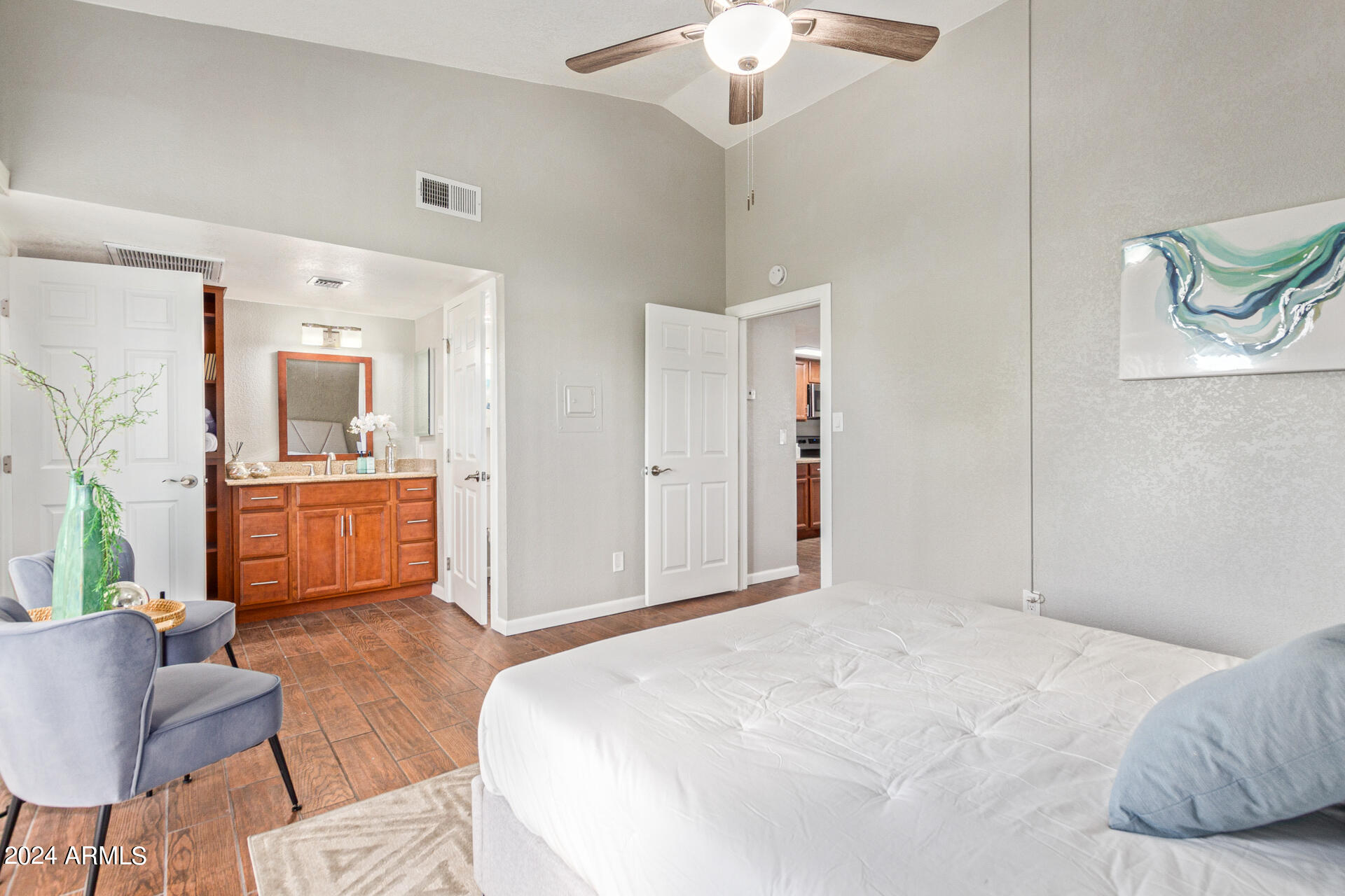 1602 East Ocotillo Road, Unit 121 Phoenix, AZ 85016 - Photo 16 of 31 a bedroom with a bed and a chandelier