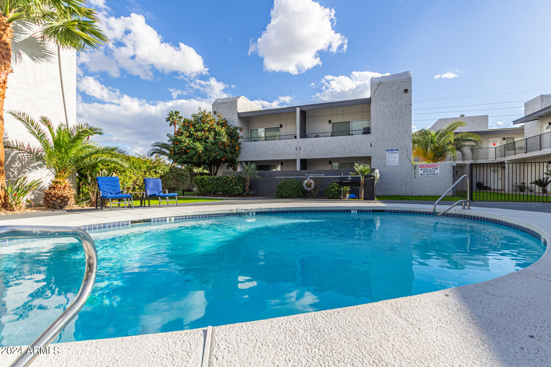 1602 East Ocotillo Road, Unit 121 Phoenix, AZ 85016 - Photo 28 of 31 a view of a swimming pool with a garden