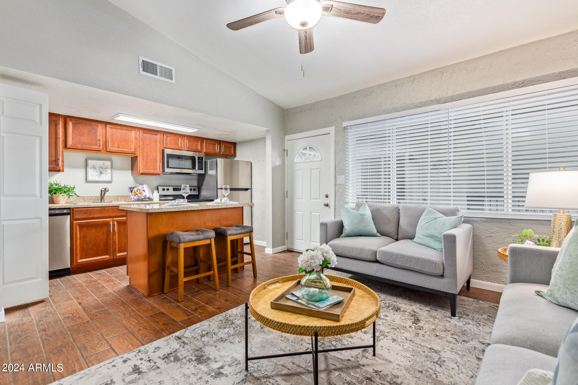 1602 East Ocotillo Road, Unit 121 Phoenix, AZ 85016 - Photo 6 of 31 a living room with furniture a rug and a large window