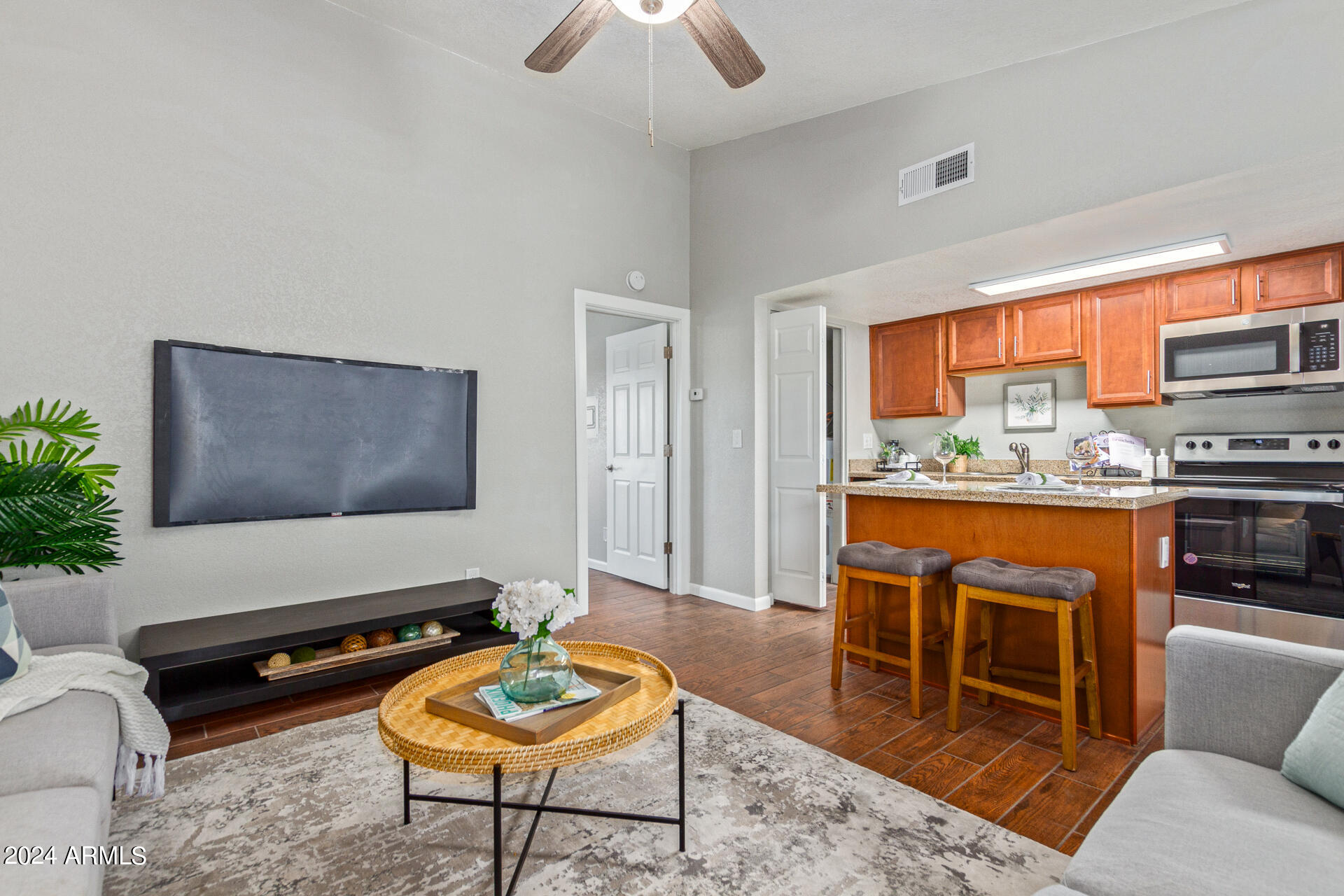 1602 East Ocotillo Road, Unit 121 Phoenix, AZ 85016 - Photo 7 of 31 a living room with a couch and a flat screen tv