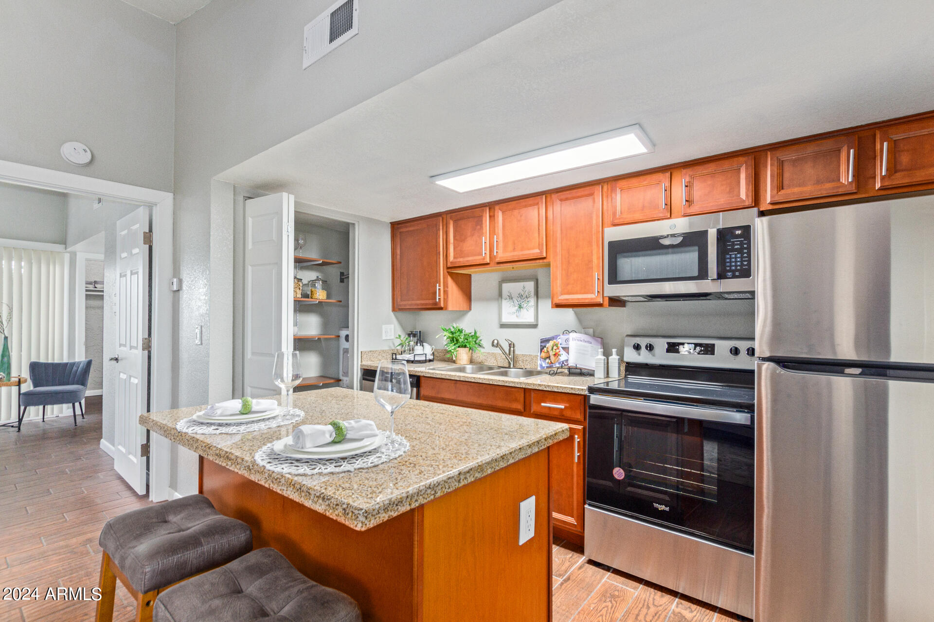1602 East Ocotillo Road, Unit 121 Phoenix, AZ 85016 - Photo 8 of 31 a kitchen with stainless steel appliances granite countertop a stove a refrigerator and a stove