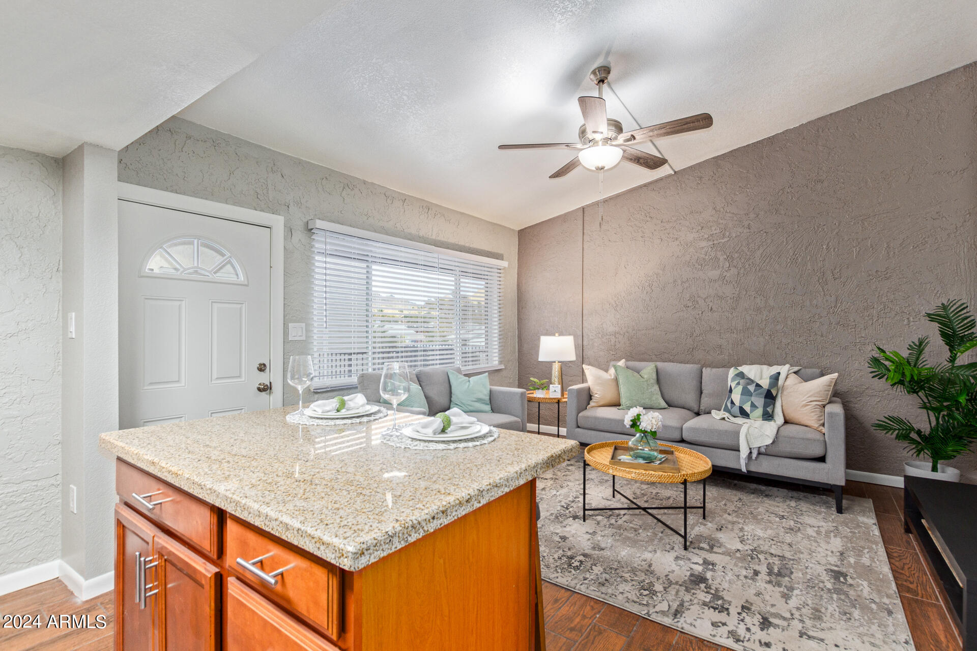 1602 East Ocotillo Road, Unit 121 Phoenix, AZ 85016 - Photo 10 of 31 a living room with granite countertop kitchen island furniture and a chandelier