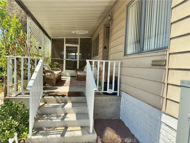 a view of staircase with white walls and windows