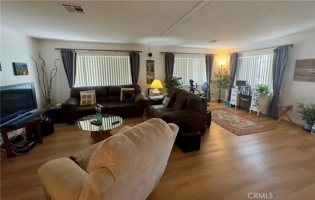 8651 Foothill Boulevard, Unit 18 Rancho Cucamonga, CA 91730 - Photo 5 of 12 a living room with furniture wooden floor and a window
