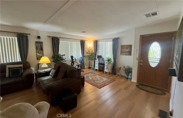 a living room with furniture potted plant and a window