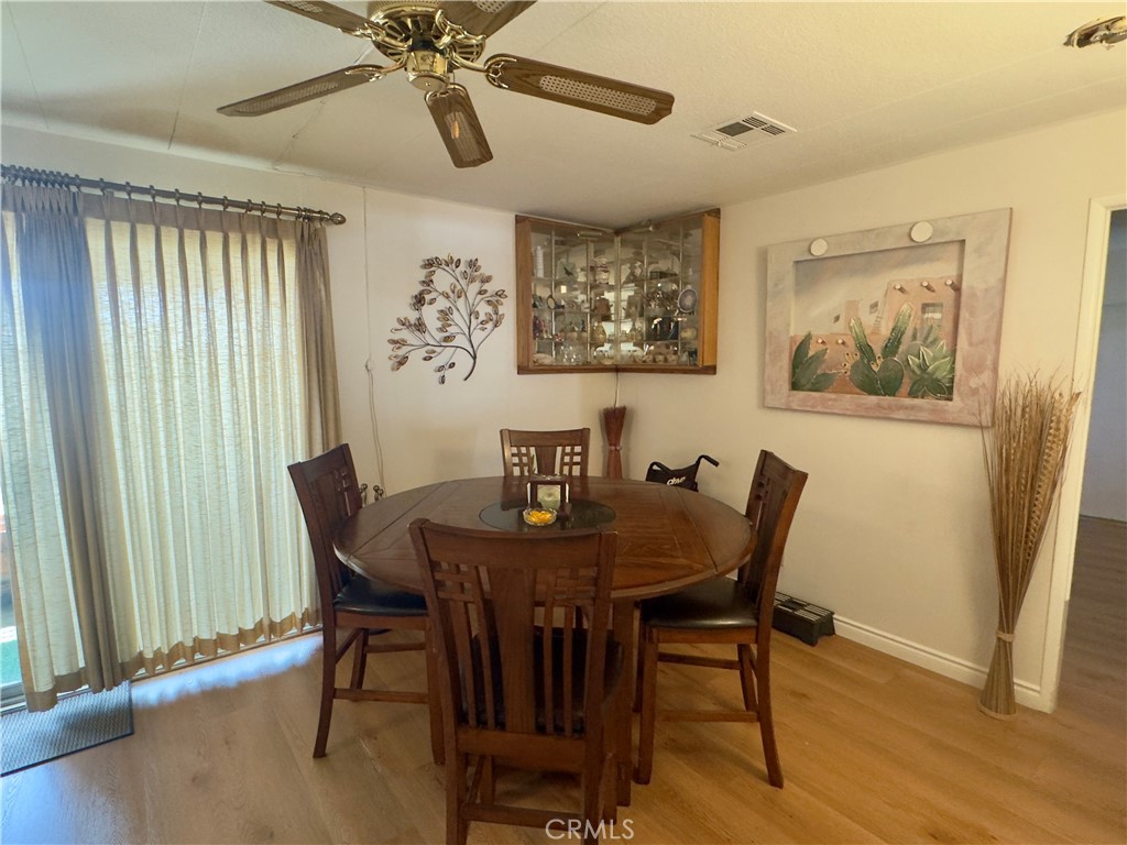 8651 Foothill Boulevard, Unit 18 Rancho Cucamonga, CA 91730 - Photo 9 of 12 a view of a dining room with furniture and wooden floor