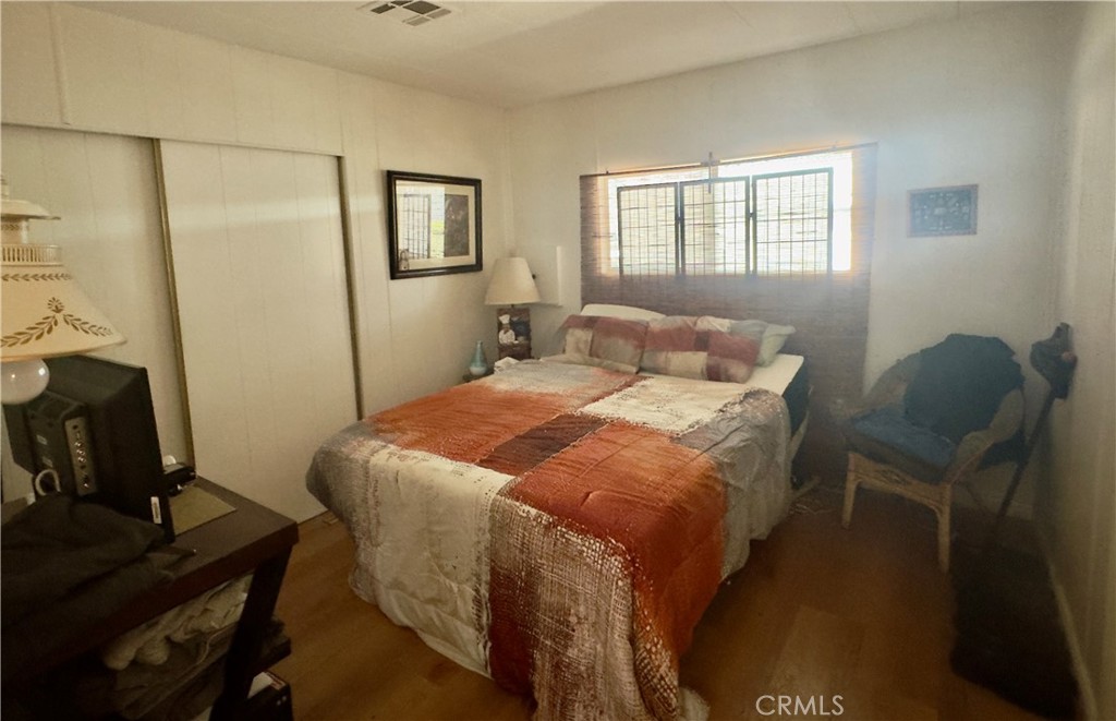 8651 Foothill Boulevard, Unit 18 Rancho Cucamonga, CA 91730 - Photo 10 of 12 a bedroom with a bed and a window