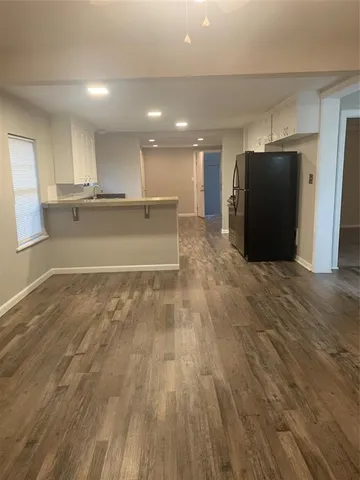 a view of kitchen empty room with wooden floor