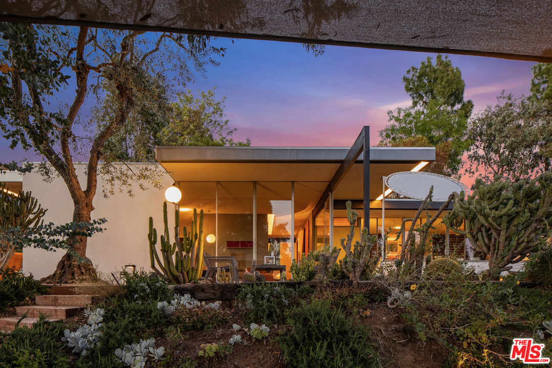 1531 North Tigertail Road Los Angeles, CA 90049 - Photo 22 of 24 a view of a house with a tree and a yard