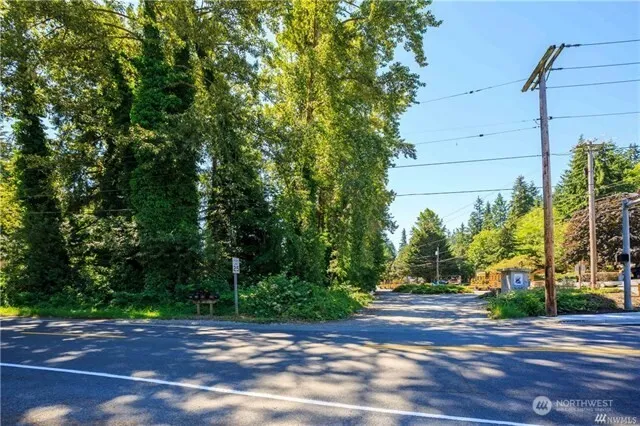 a view of a road with a house in the background