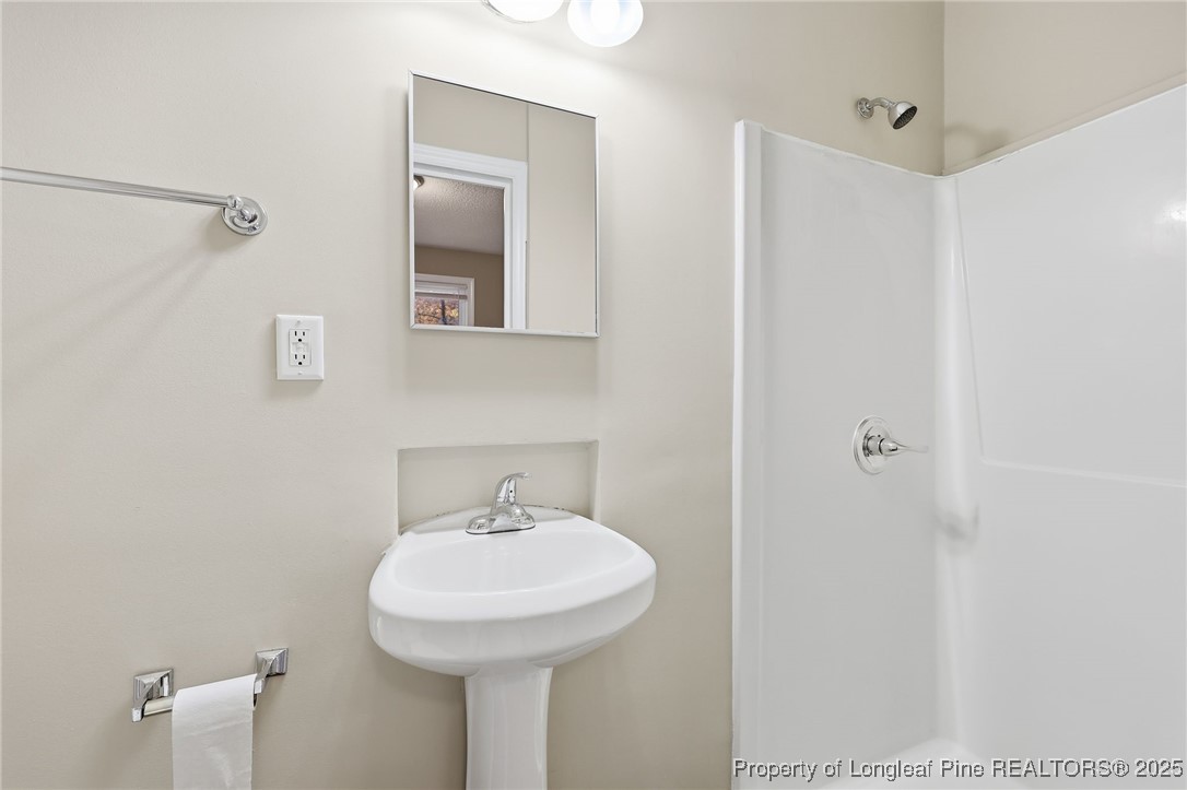 3204 Hickory Road Raleigh, NC 27616 - Photo 13 of 49 a bathroom with a sink and mirror