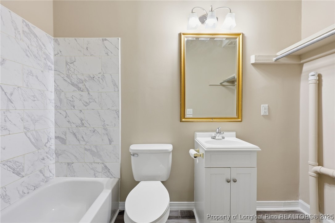 3204 Hickory Road Raleigh, NC 27616 - Photo 14 of 49 a bathroom with a sink a toilet and shower