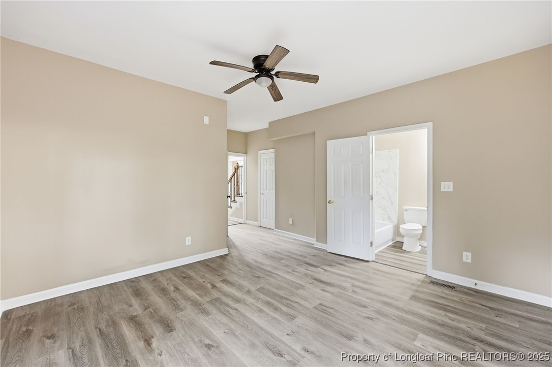 3204 Hickory Road Raleigh, NC 27616 - Photo 15 of 49 a view of empty room with wooden floor and ceiling fan