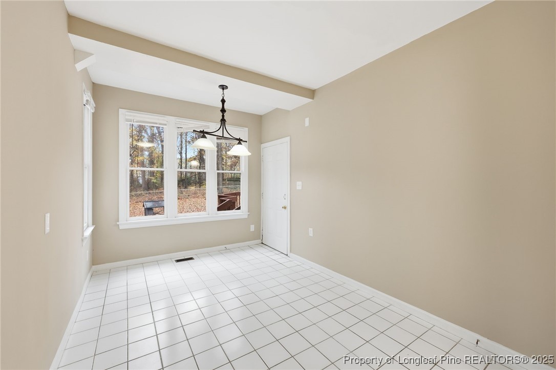 3204 Hickory Road Raleigh, NC 27616 - Photo 17 of 49 a view of an empty room with chandelier fan