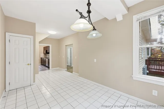 a view of a bedroom with wooden floor