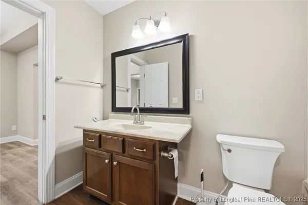a bathroom with a toilet a sink and mirror