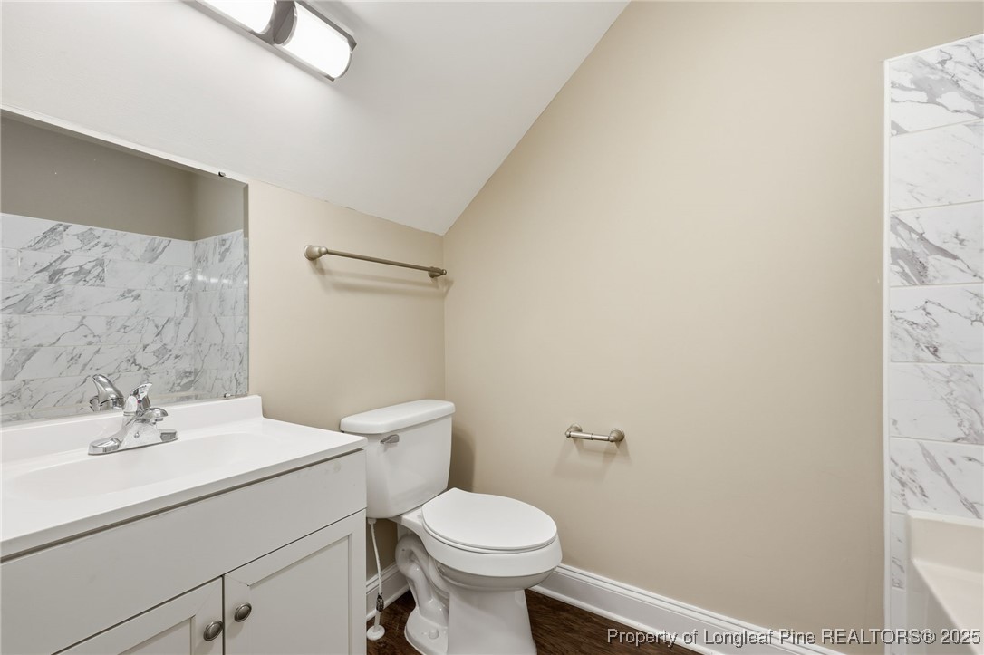 3204 Hickory Road Raleigh, NC 27616 - Photo 33 of 49 a bathroom with a sink a toilet and a mirror