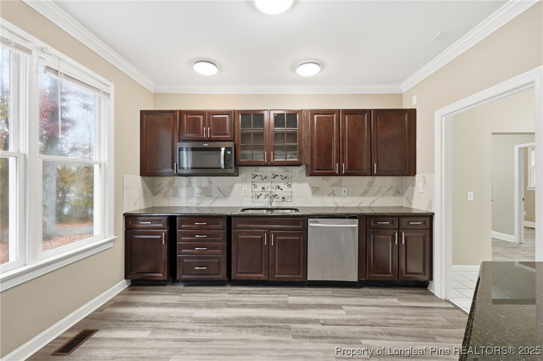 3204 Hickory Road Raleigh, NC 27616 - Photo 44 of 49 a kitchen with stainless steel appliances granite countertop a stove and cabinets