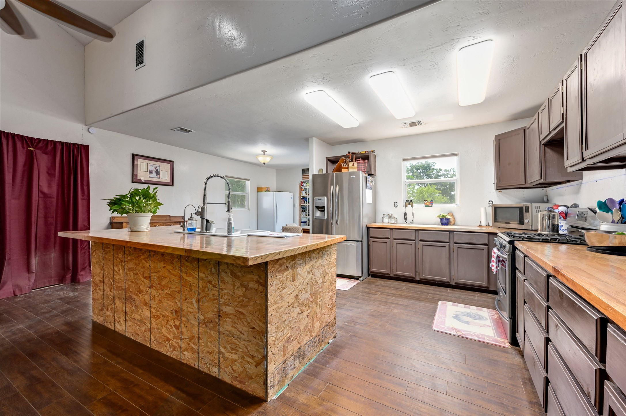 681 County Road 474 Elgin, TX 78621 - Photo 7 of 37 a kitchen with stainless steel appliances a sink a counter top space a large window and stainless steel appliances