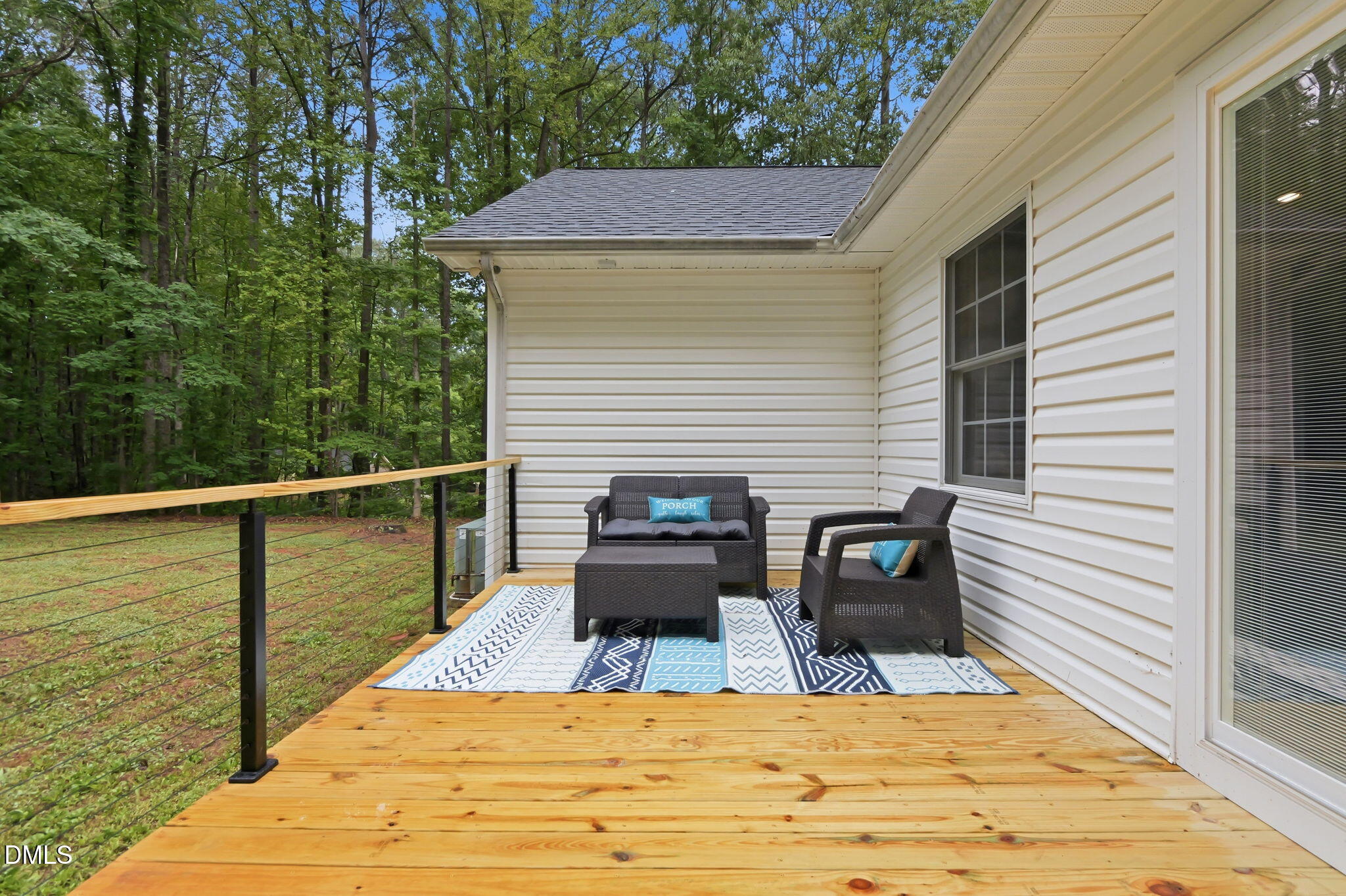 1925 Old Allensville Road Roxboro, NC 27574 - Photo 21 of 58 a view of a balcony with two chairs and a wooden floor