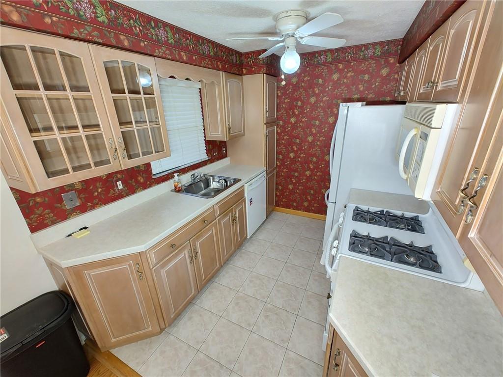 7448 Lighthouse Point Pittsburgh, PA 15221 - Photo 13 of 36 a kitchen with stainless steel appliances granite countertop a stove and a refrigerator