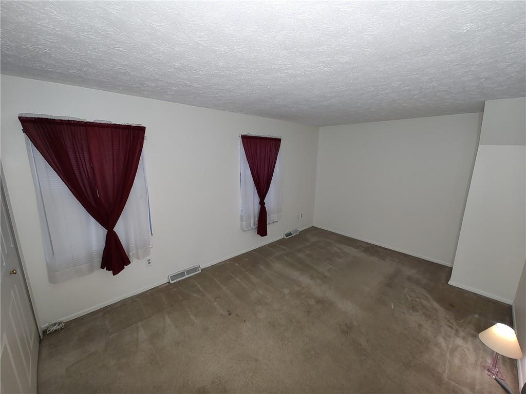 7448 Lighthouse Point Pittsburgh, PA 15221 - Photo 24 of 36 a view of a hallway to room with wooden floor and cabinet