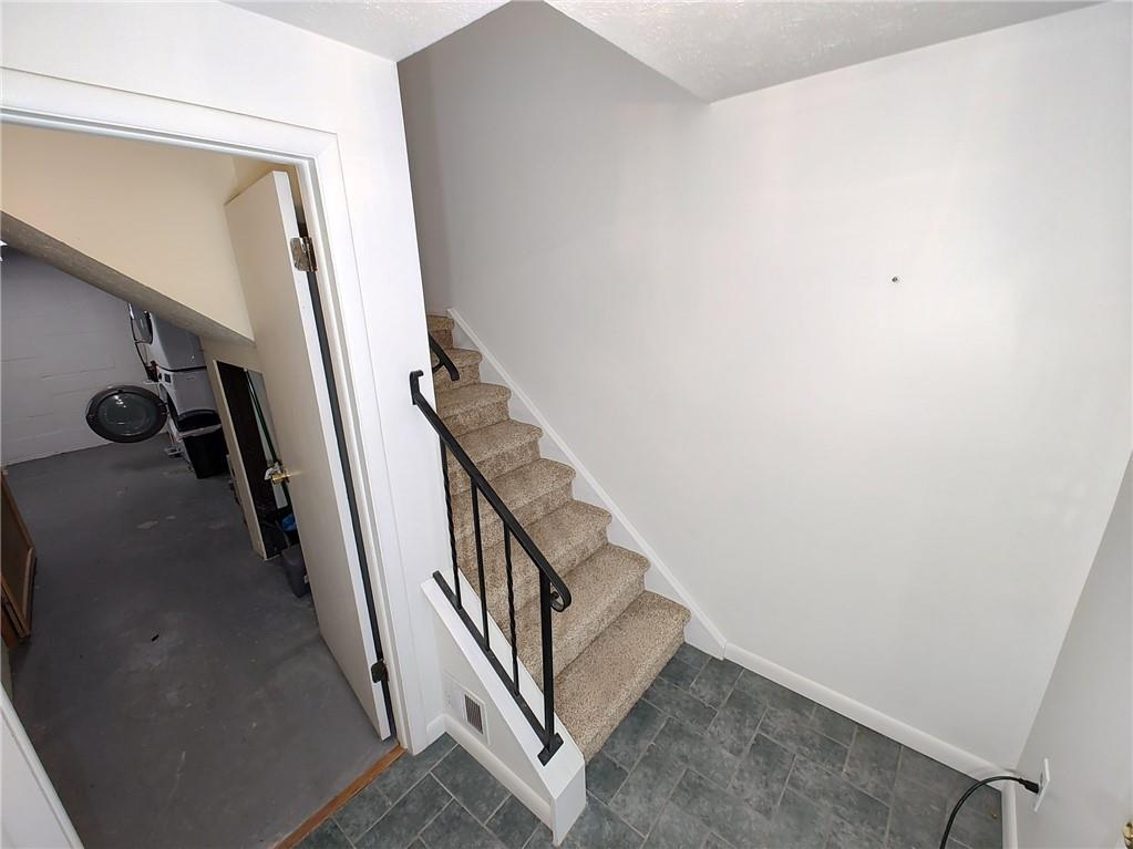 7448 Lighthouse Point Pittsburgh, PA 15221 - Photo 30 of 36 a view of a hallway with staircase