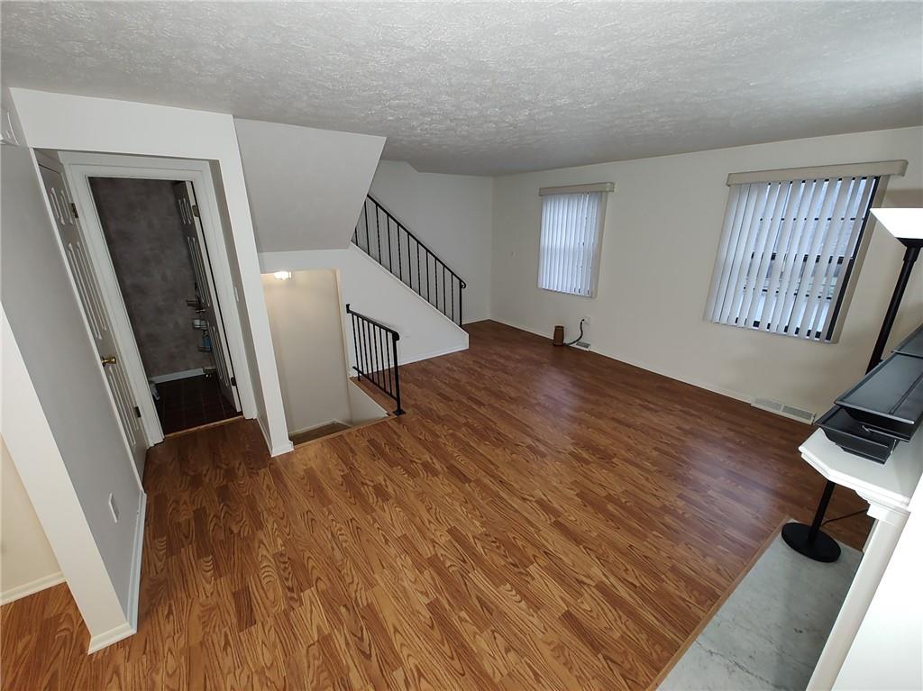 7448 Lighthouse Point Pittsburgh, PA 15221 - Photo 3 of 36 a view of entryway with stairs and wooden floor