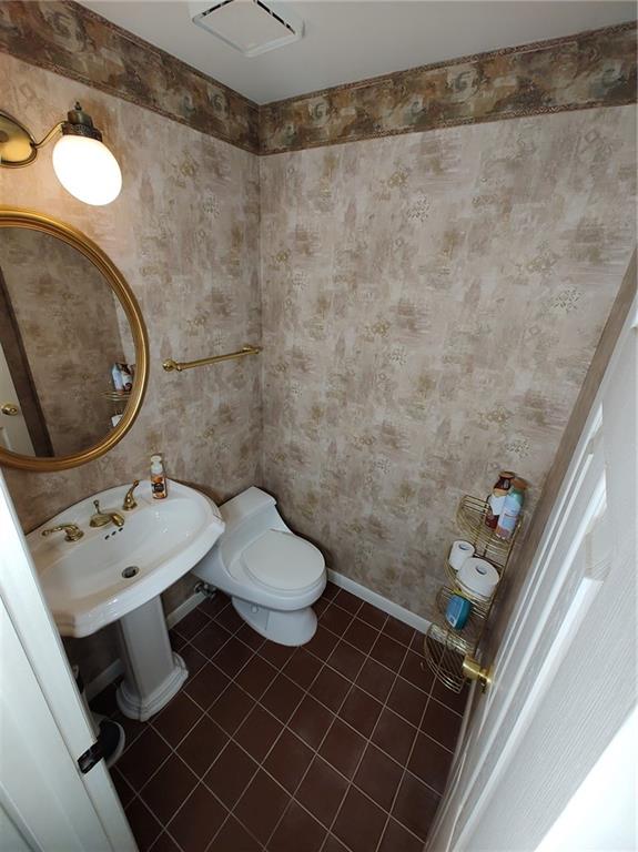 7448 Lighthouse Point Pittsburgh, PA 15221 - Photo 6 of 36 a bathroom with a sink mirror vanity and toilet