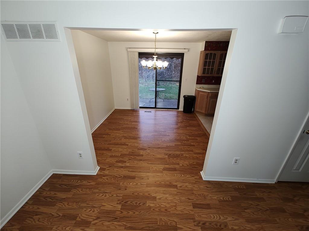 7448 Lighthouse Point Pittsburgh, PA 15221 - Photo 7 of 36 wooden floor in an empty room with a window