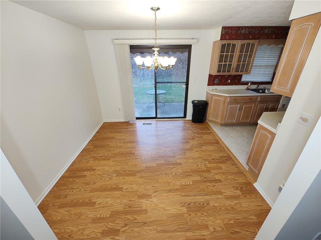 7448 Lighthouse Point Pittsburgh, PA 15221 - Photo 8 of 36 a view of a kitchen with fridge and wooden floor