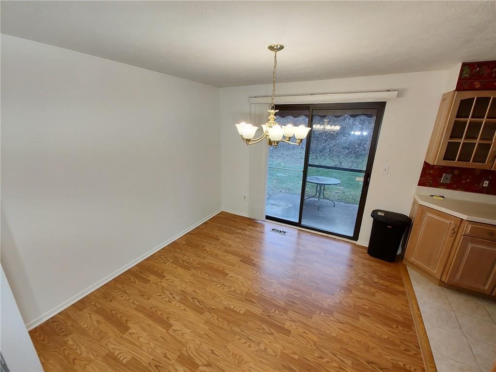 7448 Lighthouse Point Pittsburgh, PA 15221 - Photo 10 of 36 a view of empty room with wooden floor and fan