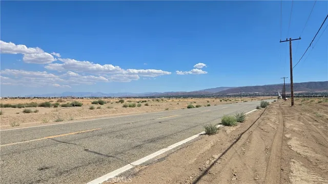 a view of a room with an empty space and a mountain view