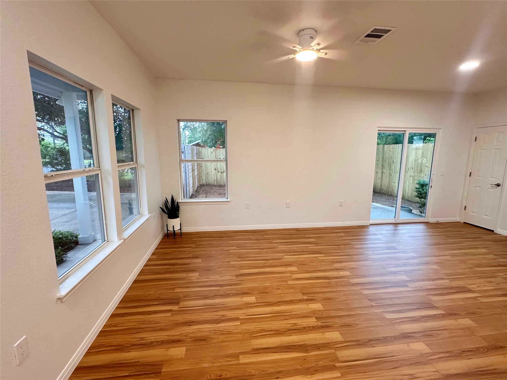 1122 Mansell Avenue Austin, TX 78721 - Photo 3 of 29 a view of an empty room with wooden floor and a window