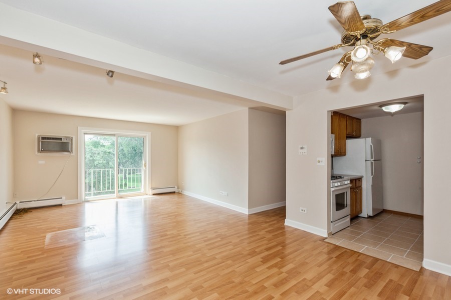 238 East Bailey Road, Unit M Naperville, IL 60565 - Photo 2 of 10 a view of an empty room with a window and wooden floor