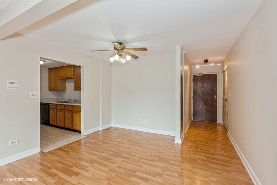238 East Bailey Road, Unit M Naperville, IL 60565 - Photo 4 of 10 a view of a hallway with wooden floor and a kitchen