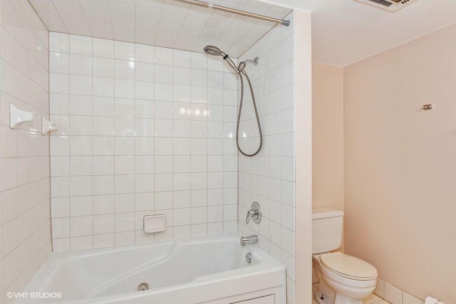 238 East Bailey Road, Unit M Naperville, IL 60565 - Photo 7 of 10 a bathroom with a shower a toilet and a shower
