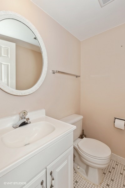 238 East Bailey Road, Unit M Naperville, IL 60565 - Photo 9 of 10 a bathroom with a sink a toilet and a mirror
