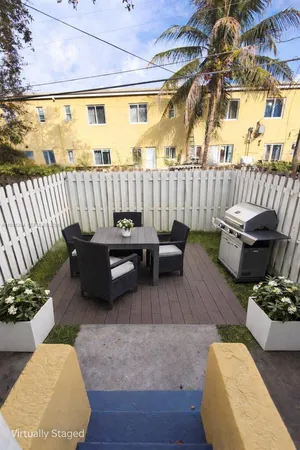 a balcony with furniture and wooden floor