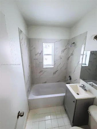 a white bath tub sitting next to a white sink