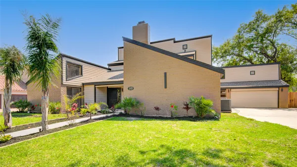 a view of a house with a yard and garage